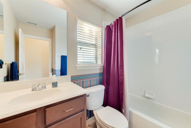 full bathroom with vanity, toilet, and shower / tub combo with curtain