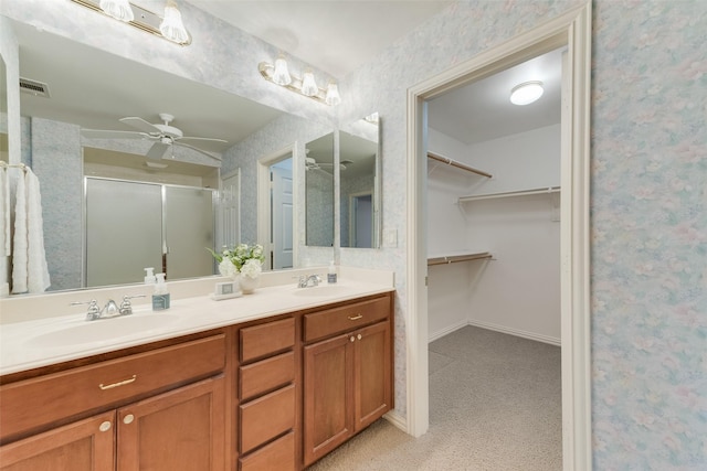 10104 Southpoint Ct, Denton, TX 76207 - bathroom featuring ceiling fan, a shower stall, double vanity, wallpapered walls, and a spacious closet