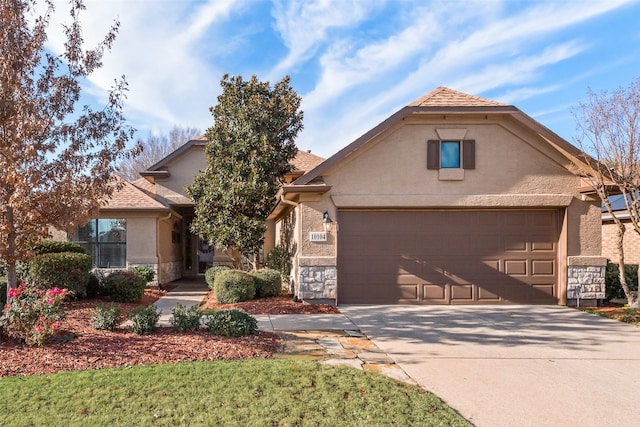 10104 Southpoint Ct, Denton, TX 76207 - view of front of house with stucco siding, driveway, and stone siding
