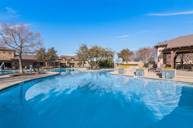 view of pool with pool water feature and a patio area