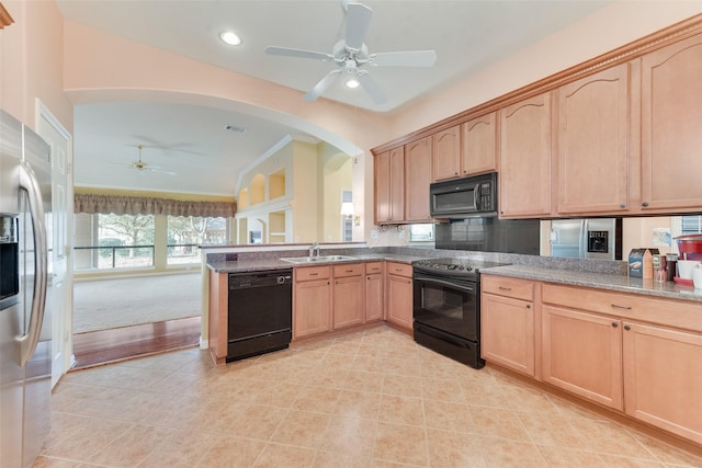 kitchen with kitchen peninsula, sink, black appliances, and light brown cabinets