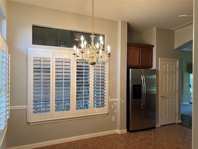 10104 Southpoint Ct, Denton, TX 76207 - unfurnished dining area with a chandelier, dark tile patterned floors, and baseboards
