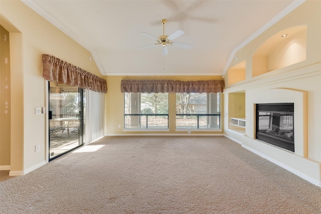 unfurnished living room with carpet, ceiling fan, lofted ceiling, and crown molding