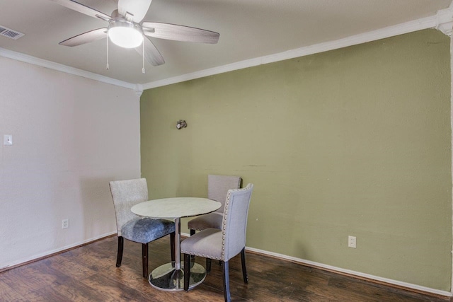 dining area featuring ceiling fan, crown molding, and dark wood-type flooring