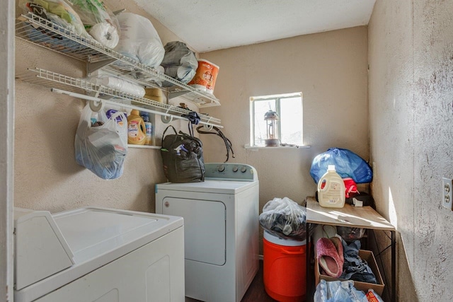 clothes washing area with washing machine and dryer