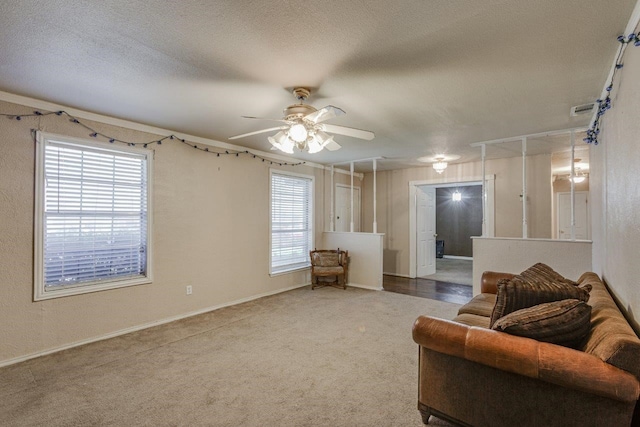 carpeted living room featuring ceiling fan and a healthy amount of sunlight