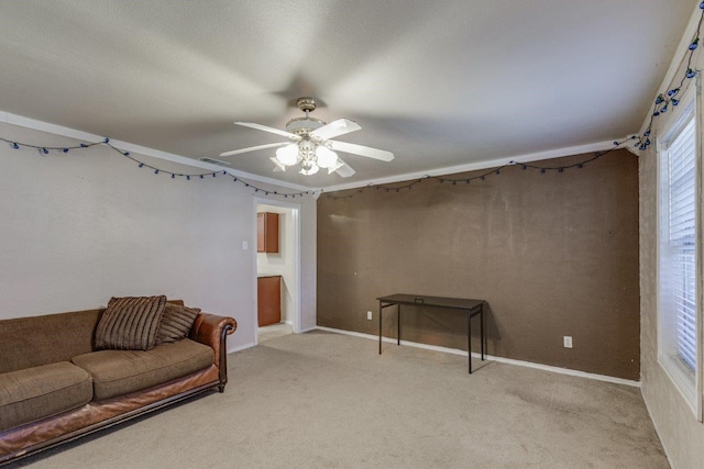 carpeted living room featuring ceiling fan