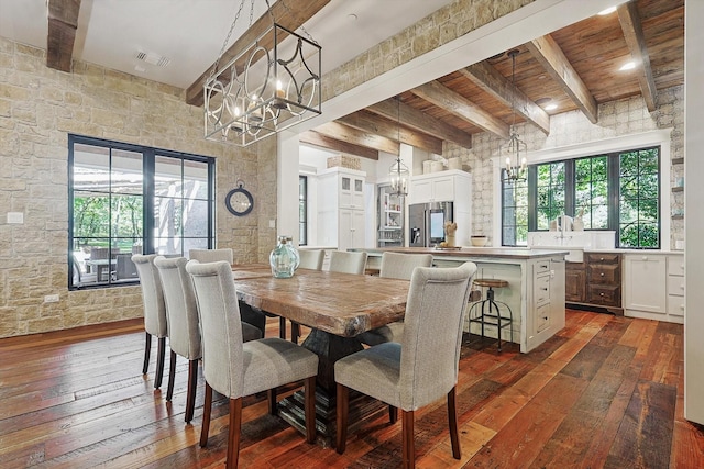 dining room with a notable chandelier, dark hardwood / wood-style floors, and beamed ceiling