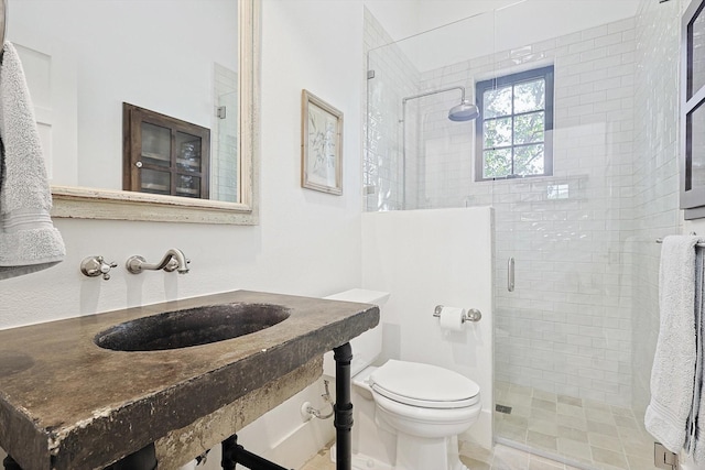 bathroom featuring sink, toilet, and walk in shower