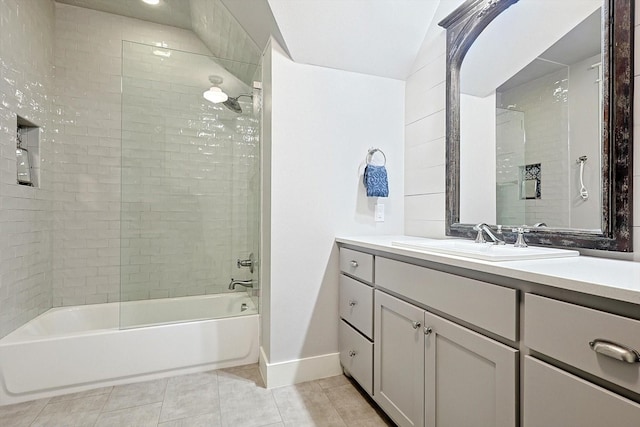 bathroom with tiled shower / bath, tile patterned floors, and vanity