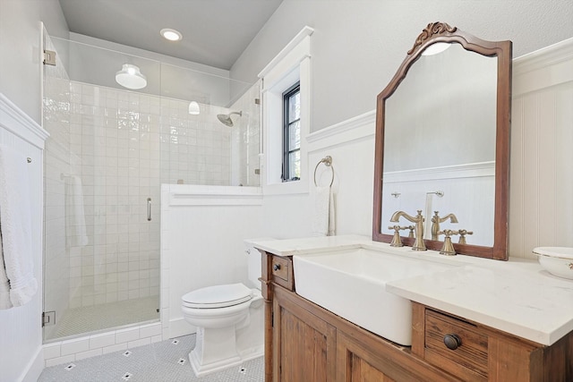 bathroom with vanity, tile patterned floors, toilet, and walk in shower