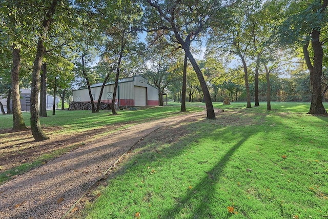 view of yard featuring a garage and an outdoor structure