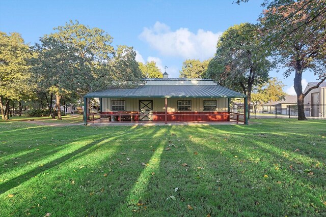 rear view of house featuring a lawn