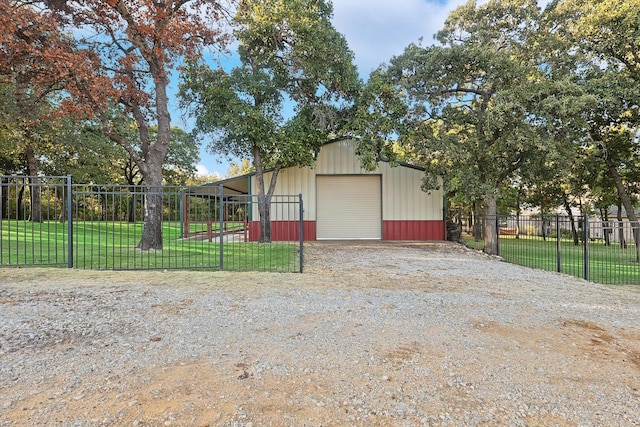 view of outbuilding featuring a garage and a yard