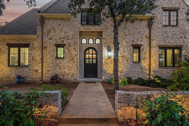 view of exterior entry at dusk