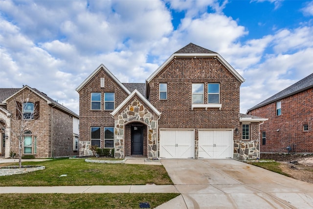 view of front of property with a garage and a front lawn