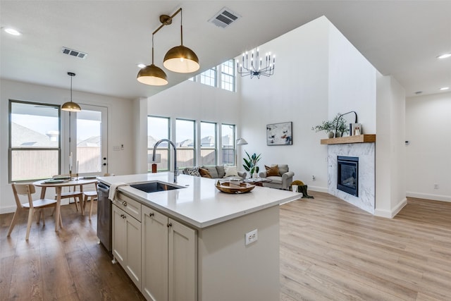 kitchen featuring decorative light fixtures, open floor plan, light countertops, and visible vents