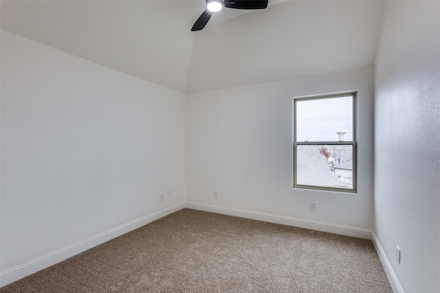 unfurnished room featuring lofted ceiling, a ceiling fan, baseboards, and carpet flooring