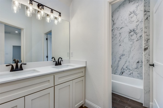 bathroom with double vanity, a sink, visible vents, and wood tiled floor