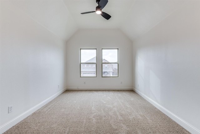 bonus room featuring baseboards, lofted ceiling, and light colored carpet