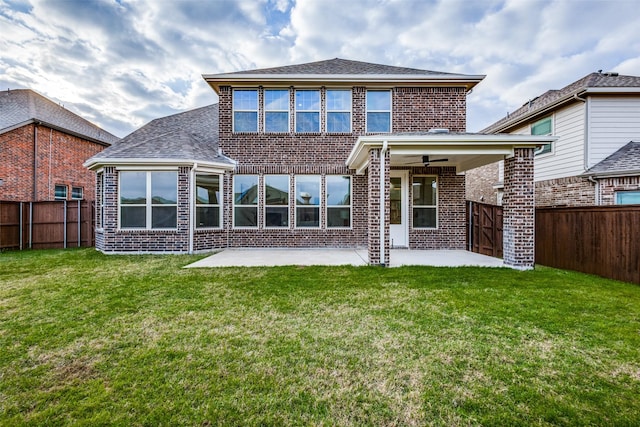 rear view of property featuring a ceiling fan, brick siding, a patio, and a fenced backyard