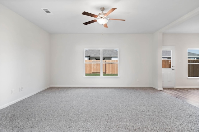 carpeted spare room with ceiling fan