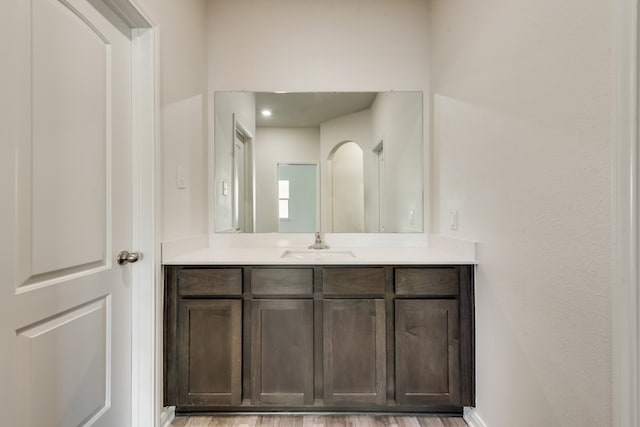 bathroom with hardwood / wood-style floors and vanity