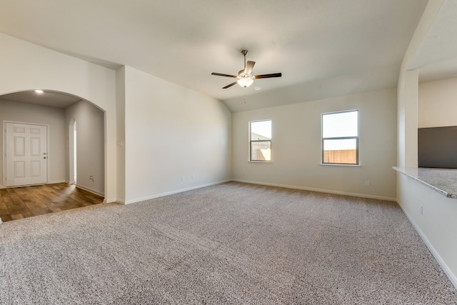 interior space featuring light colored carpet, ceiling fan, and lofted ceiling