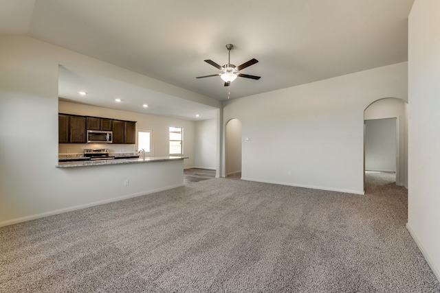 unfurnished living room with light carpet, ceiling fan, and lofted ceiling