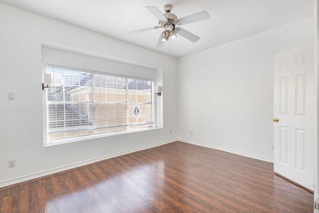 empty room featuring ceiling fan and dark wood-type flooring