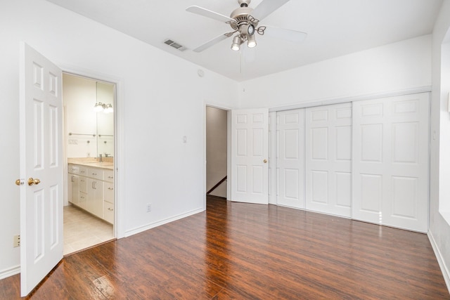 unfurnished bedroom featuring connected bathroom, a closet, ceiling fan, and hardwood / wood-style floors