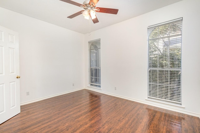 spare room featuring ceiling fan and dark wood-type flooring