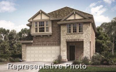 view of front of home featuring an attached garage, stone siding, and driveway