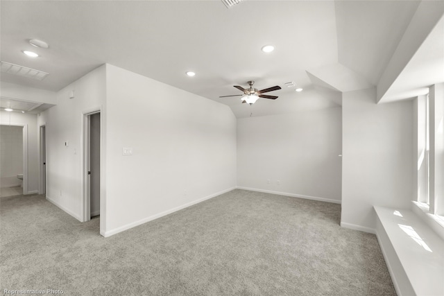 carpeted empty room with ceiling fan and lofted ceiling