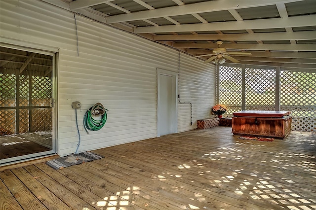 wooden deck featuring ceiling fan and a hot tub