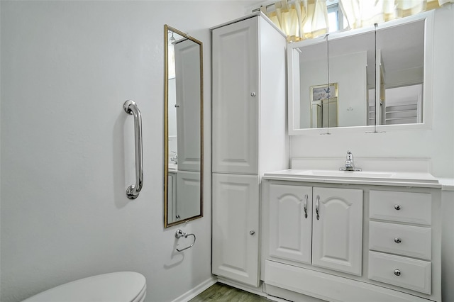 bathroom featuring vanity and toilet