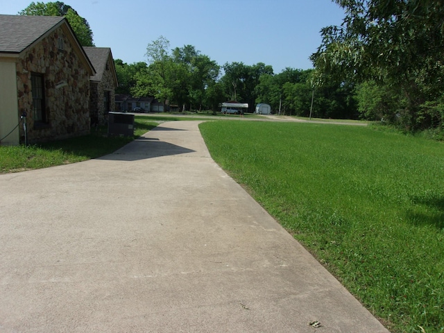 view of home's community with a yard