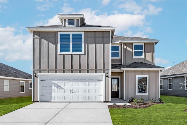 view of front facade with a front yard and a garage