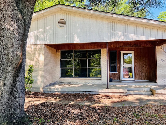 1721 Cooper Dr, Irving, TX 75061 - rear view of house with a porch and brick siding