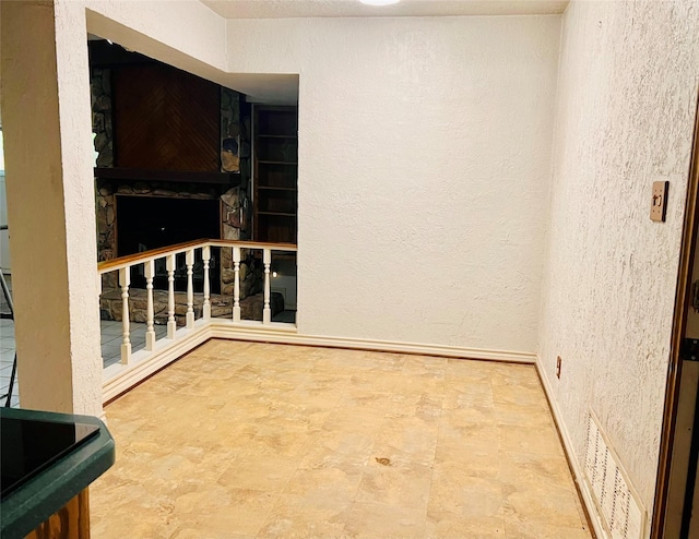 1721 Cooper Dr, Irving, TX 75061 - spare room featuring visible vents, a textured wall, and baseboards