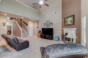 living room featuring ceiling fan, carpet floors, and high vaulted ceiling