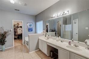 bathroom featuring tile patterned flooring, vanity, and plus walk in shower