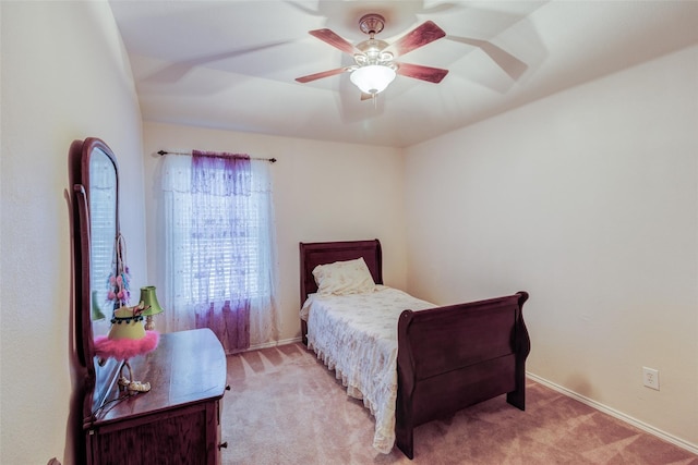 bedroom with ceiling fan and light carpet