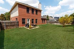 back of house featuring a yard