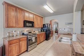 kitchen featuring black appliances and light tile patterned floors