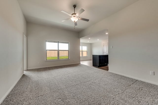 empty room with dark carpet and ceiling fan