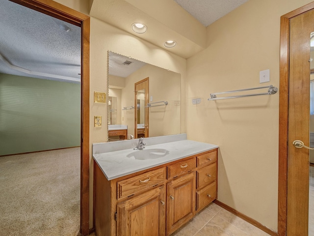 bathroom featuring vanity and a textured ceiling