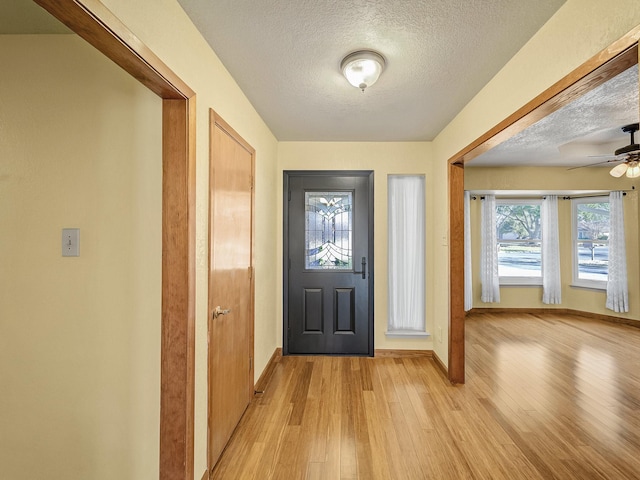 entrance foyer featuring light hardwood / wood-style flooring and a textured ceiling