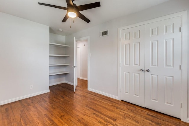 unfurnished bedroom with hardwood / wood-style flooring, ceiling fan, and a closet