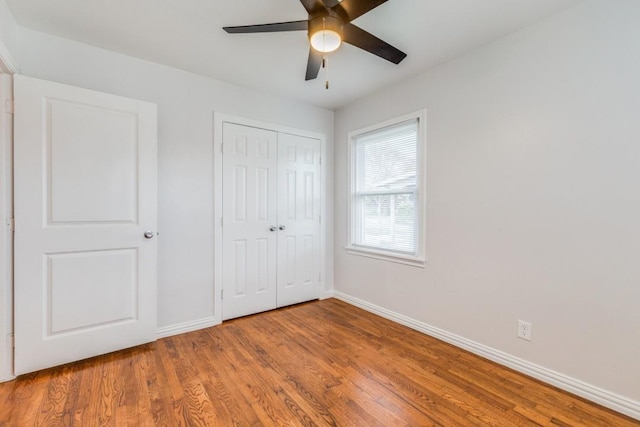 unfurnished bedroom with ceiling fan, light hardwood / wood-style floors, and a closet